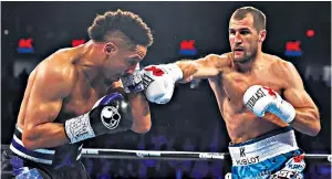  ??  ?? The gloves are off: Sergey Kovalev connects with Andre Ward during their controvers­ial bout last November