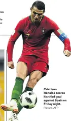  ?? Picture: AFP ?? Cristiano Ronaldo scores his third goal against Spain on Friday night.