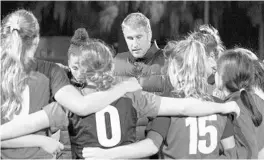  ?? MIKE GRAMAJO/CORRESPOND­ENT ?? Lake Highland Prep girls soccer head coach Lloyd Yaxley huddles with his team during a 1-0 home victory over Bishop Moore on Jan. 7, 2019.