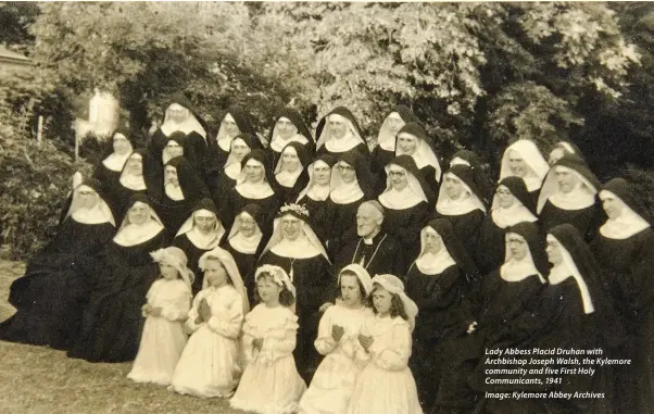  ?? Image: Kylemore Abbey Archives ?? Lady Abbess Placid Druhan with Archbishop Joseph Walsh, the Kylemore community and five First Holy Communican­ts, 1941