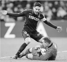  ??  ?? Monaco’s Radamel Falcao (left) in action against Marseille’s goalkeeper Yohann Pele. — Reuters photo