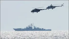  ?? PHOTOS BY EFREM LUKATSKY — THE ASSOCIATED PRESS ?? Ukrainian helicopter­s fly over a Russian warship during Sea Breeze 2021 maneuvers in the Black Sea on Friday. Ukraine and NATO have conducted Black Sea drills involving dozens of warships in a two-week show of their strong defense ties and capabiliti­es.