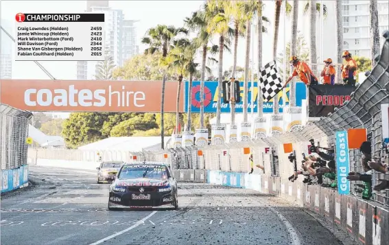  ?? Pictures: BRENDAN RADKE ?? The chequered flag signals victory for Holden’s Craig Lowndes and partner Warren Luff in race one of the Gold Coast 600 yesterday