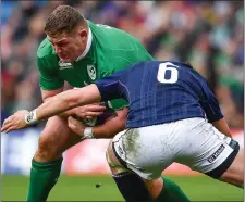  ??  ?? Tadhg Furlong is tackled by Ryan Wilson of Scotland.