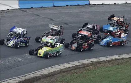  ?? CLIFFORD SKARSTEDT EXAMINER ?? Drivers race in tight formation during day two of the 26th Autumn Colours Classic stock car races at Peterborou­gh Speedway on Saturday.