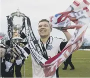  ??  ?? 2 Goalscorer Craig Moore parades the League 1 trophy after Ayr United’s win over Albion Rovers at Somerset Park.