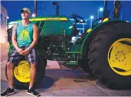  ?? PHOTO BY ANDREW NELLES / THE TENNESSEAN ?? Curtis Carney, owner of Off the Wagon Tours, poses for a portrait on his tractor in Nashville.
