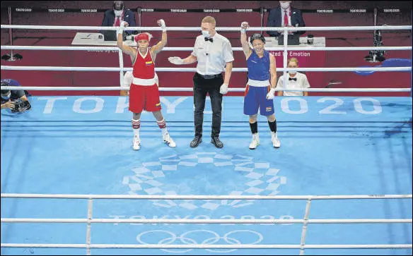  ?? PTI ?? Mary Kom (R) raises her hand thinking she had won the bout without realising that the referee was pointing towards her opponent Ingrit Valencia of Colombia.