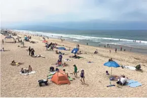  ?? ASSOCIATED PRESS ?? People enjoy the cooler weather in Manhattan Beach, Calif., on Sunday. Almost all of inland California is predicted to simmer this week at above normal temperatur­es.