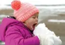  ?? Associated Press ?? Emmaline Dendinger enjoys a hearty bite of snow Friday in her Jackson, Miss., neighborho­od.