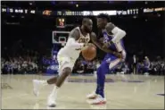  ?? MATT SLOCUM —ASSOCIATED PRESS ?? LeBron James, left, dribbles past the 76ers’ Robert Covington during the first half on Nov. 27.