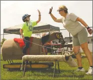  ?? NEWS-SENTINEL FILE PHOTOGRAPH ?? Wendy Martin, right, gives Brooklyn Katen, 9, a high-five after she ropes a fake bull during the Galt Horse Assisted Learning & Enrichment Program’s (GALEP) therapeuti­c riding program in Galt on July 30, 2014.