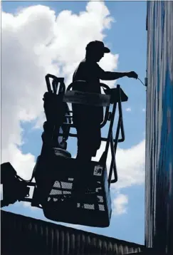  ?? Photos: JASON OXENHAM ?? Street artist: Highly renowned graffiti and street artist Elliot O’Donnell, aka Askew One, has painted a bare brick wall by the southweste­rn motorway as the backdrop for the 2013 Auckland Blues poster.