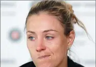  ?? PETR DAVID JOSEK / AP ?? World No 1 Angelique Kerber grimaces during a media conference after losing to Ekaterina Makarova in their first-round match at the French Open on Sunday.