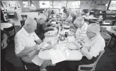  ?? NWA Democrat-Gazette/DAVID GOTTSCHALK ?? Cyril Sturm (left) and Phil Wilson (right) begin eating their breakfast Wednesday at the Village Inn. The waitress Dee McCarthy and manager Carol Gray know the men so well, that the men merely need to nod to place their orders.