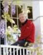  ?? DAVID J. PHILLIP — THE ASSOCIATED PRESS FILE ?? This 2004 file photo shows Arnold Palmer as he sits on clubhouse railing at the Augusta National Golf Club in Augusta, Ga.