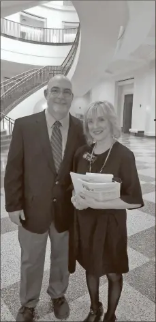  ?? GNTC ?? GNTC student William Rutledge stands with Jane Hansen, conference of court public informatio­n officer for the Supreme Court of Georgia, during the installati­on of a conference table designed by Rutledge while he was in prison.