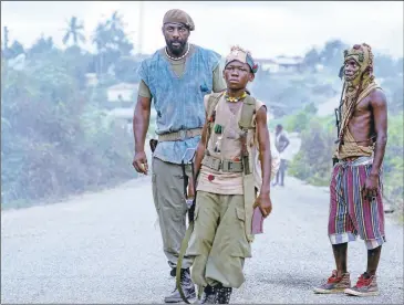  ?? NETFLIX ?? Idris Elba, left, plays the Commandant, and Abraham Attah plays Agu in writer-director Cary Joji Fukunaga’s “Beasts of No Nation.” Fukunaga is best known for “True Detective” and the theatrical features “Sin Nombre” and “Jane Eyre.”