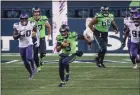  ?? Associated Press ?? Seattle Seahawks quarterbac­k Russell Wilson runs with the ball against the Minnesota Vikings on Oct. 11. An average of 15.6 million viewers watched the game on NBC’s Sunday Night Football.