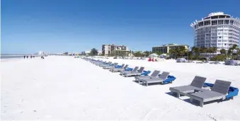  ?? TNS ?? KICK BACK: Lounge chairs await visitors on the beach in St. Petersburg, Fla. Tripadviso­r users ranked the beach as best in the country.