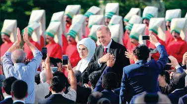  ?? UMIT BEKTAS / REUTERS ?? Turkish President Tayyip Erdogan, accompanie­d by his wife Emine Erdogan, arrives for a ceremony at the Presidenti­al Palace in