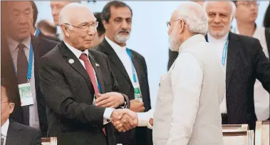  ?? PTI ?? Prime Minister Narendra Modi shakes hands with Sartaj Aziz, Pakistan Prime Minister’s Adviser on Foreign Affairs, at the SCO Heads of State Council meeting in Tashkent, Friday.