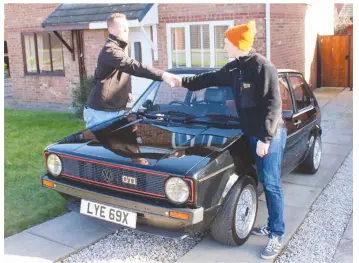  ??  ?? Congratula­tions, you’ve just bought a 1981 Golf GTI. Lancaster Insurance’s Dave Youngs (left) seals the deal with Jonny, the VW’s former owner.