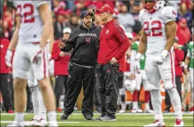  ?? ASSOCIATED PRESS ?? First-year coach Scott Frost (second from right) plans to rely heavily on Nebraska legend Tom Osborne, who has embraced the program after a hiatus.