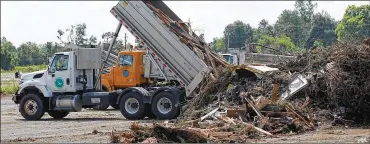  ?? CHRIS STEWART / STAFF ?? Trucks from municipali­ties across the county, as well as those from the Ohio Department of Transporta­tion, move tornado debris to staging areas in Harrison Twp. on Thursday.