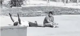  ?? HILTON NAPOLEON ?? In this July 2016 photo, Charles Kinsey lies prone in the street while his patient, Arnaldo Rios-Soto, plays with a toy truck. Kinsey was hit by a bullet fired by a North Miami police officer that was apparently meant for Rios-Soto, who was incorrectl­y described by a witness as armed.