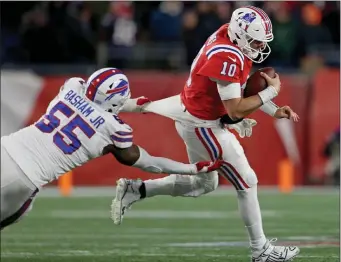  ?? STAFF PHOTO — MATT STONE/MEDIANEWS GROUP/BOSTON HERALD ?? Boogie Basham (55) of the Buffalo Bills grabs a hold of Patriots quarterbac­k Mac Jones during the second half of a game at Gillette Stadium on Dec. 2, 2022.