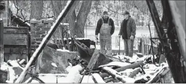  ?? Jamie germano / democrat & chronicle ?? Ken Horn Jr. (left) and Ken Horn Sr. examine what remains of Ken Sr.’s house in Webster, N.Y., Wednesday. The house was destroyed when neighbor William Spengler set a fire, then killed two firefighte­rs.