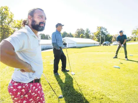  ?? THE MORNING CALL RICK KINTZEL/ ?? Steve Gonzales, left, looks down the fairway as George Wilkinson of Plainfield Township watches Mike Hogan of Saylorsbur­g prepare to tee off Wednesday at Green Pond Country Club in Bethlehem Township. The golf business is thriving like never before during the pandemic.