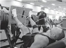  ??  ?? A trainer and club member on July 2 at Mountainsi­de Fitness in Phoenix, Arizona. [AP PHOTO/ROSS D. FRANKLIN, FILE]