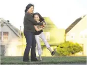  ?? JEFF CHIU/AP ?? Joyce Chen hugs her daughter, Kathryn, 10, in San Francisco.