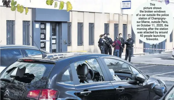  ??  ?? This picture shows the broken windows of a car outside the police station of Champignys­ur-marne, outside Paris, on October 11, 2020, the morning after the station was attacked by around 40 people launching fireworks.