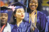  ?? Ned Gerard / Hearst Connecticu­t Media ?? Marta Villegras, of Fairfield, blows a kiss toward the crowd while entering commenceme­nt for the Housatonic Community College Class of 2019, held at Webster Bank Arena in Bridgeport on May 22.