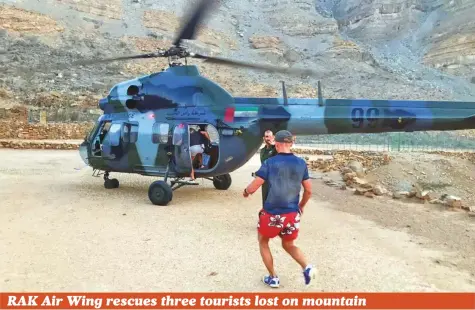  ?? Courtesy: RAK Police ?? Three European tourists who got lost on a mountain were rescued by the RAK Police Air Wing yesterday morning. Colonel Saeed Rashid Al Yamahi, who heads the Air Wing, said that his section received a report from the operations room informing them three tourists were stranded on top of Galeila mountain. The tourists informed police they could not find the way back to their car. Col Al Yamahi said a rescue helicopter was dispatched to find the tourists. They were located at a height of 4,000 feet. Col Al Yamahi urged residents and tourists to exercise caution while going on a mountain trek.