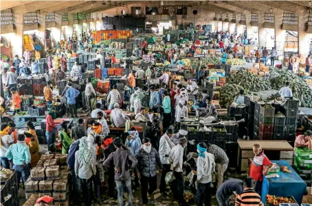  ?? PTI ?? People, not adhering to social distancing norms, visit a wholsale market during lockdown in Nagpur on Saturday. —