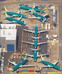  ?? Mike Siegel TNS ?? BOEING 737 Max planes sit next to the factory across the runway from Renton (Wash.) Municipal Airport on Friday.