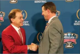  ?? GERALD HERBERT — THE ASSOCIATED PRESS ?? Clemson head coach Dabo Swinney and Alabama head coach Nick Saban, left, greet each other at a joint news conference with the Sugar Bowl trophy for their upcoming semi-final playoff game, for the NCAA football national championsh­ip, in New Orleans,...