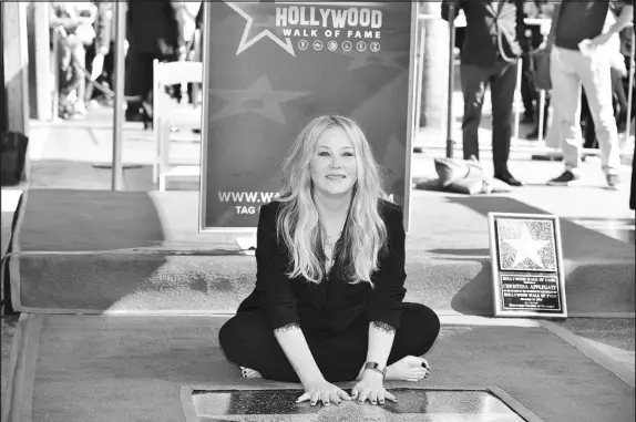  ?? RICHARD SHOTWELL / INVISION / AP FILE (2022) ?? Christina Applegate, known for her roles on “Married... with Children” and “Dead to Me,” poses Nov. 12, 2022, at a ceremony honoring her with a star on the Hollywood Walk of Fame in Los Angeles. Recently diagnosed with multiple sclerosis, Applegate says this month’s Stage Actors Guild awards show would be her last because of her condition.