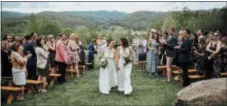  ?? JAMIE MERCURIO — JAMIE MERCURIO PHOTOGRAPH­Y VIA AP ?? Lib Tietjen, right, and her wife, Claire Skrivanos, walk up the aisle after their wedding ceremony in Fairlee, Vt. Traditiona­l weddings are deeply rooted in gender-based rituals. But the growing LGBTQ wedding industry is coming up with new approaches....