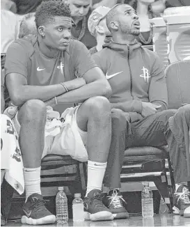  ?? Steve Yeater / Associated Press ?? The integratio­n of guard Chris Paul, right, into the system has been slowed by his bruised knee — he didn’t play in the second game. But center Clint Capela, left, helped make for his absence with 22 points and 17 rebounds against the Kings.