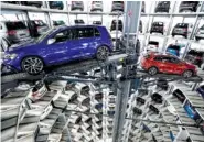  ?? ASSOCIATED PRESS FILE PHOTO ?? Volkswagen cars are lifted inside a delivery tower of the company in Wolfsburg, Germany. The automaker released figures of the first quarter 2018 Thursday.