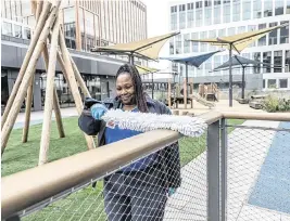  ?? HECTOR AMEZCUA hamezcua@sacbee.com ?? Jessica Gregory, a custodian with the state Department of General Services, cleans a railing in the childcare center area of the May Lee State Office Complex during its grand opening Wednesday.