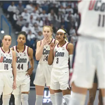  ?? CLOE POISSON/SPECIAL TO THE COURANT ?? Uconn’s Nike Muhl, from left, Aubrey Griffin, Dorka Juhasz and Aaliyah Edwards watch as teammate Lou Lopez Senechal shoots two free throws after a technical foul committed by South Carolina in the second half Sunday at the XL Center in Hartford. South Carolina won 81-77.