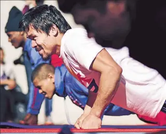  ?? Photograph­s by
Wally Skalij
Los Angeles Times ?? STILL A MAN OF THE PEOPLE , Manny Pacquiao works out at a park in L.A. in preparatio­n for next month’s mega-bout. Most of his training is done beneath trainer Freddie Roach’s Wild Card Gym.