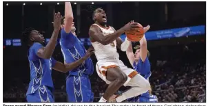  ?? (AP/Eric Gay) ?? Texas guard Marcus Carr (middle) drives to the basket Thursday in front of three Creighton defenders during the No. 2 Longhorns’ 72-67 victory over the seventh-ranked Bluejays in Austin, Texas. Carr scored 19 points in the victory.