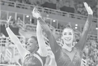  ?? Dmitri Lovetsky / Associated Press ?? The U.S. unleashed quite a 1-2 punch on the world Thursday as Simone Biles, left, and Aly Raisman followed up their victory in the team competitio­n by taking the gold and silver in the all-around.